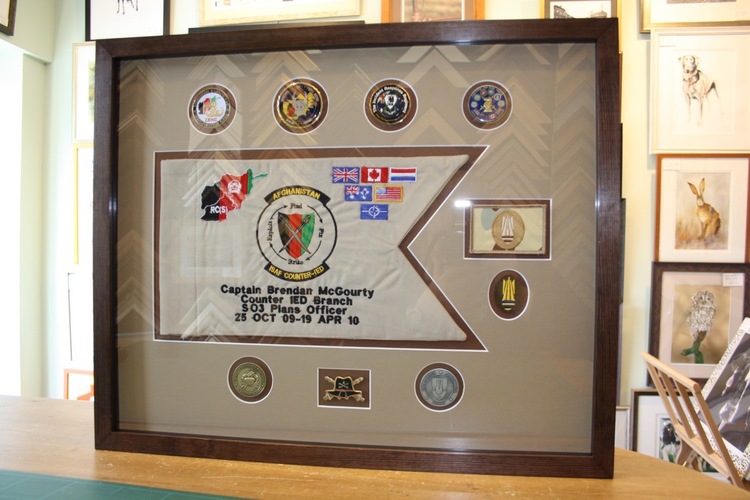 Framing a flag with a matboard allows you to have more space for customization; add badges, information tile or smaller plaques to better commemorate the flag and its historical context. 
		