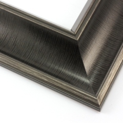 This bold frame features a steep reverse scoop profile with a broken line detail on matte black.  The inner lip drops sharply in toward the image; both edges are brushed with a subtle silver leaf.

3 " width: ideal for large or oversize artwork. Select a strong image for this frame, to ensure the heavy border doesn