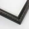 Elegant traditional molding features a beaded interior edge and raised floral design across the face. The frame is solid black with a satin finish and has a dark grey patina in the indents of the designs.