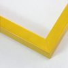 This simple frame features a warm saffron yellow base with strokes of brushed wood grain detail. It has a thin flat profile with a slightly larger side width.