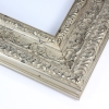 This vintage frame features highly decorative details. The moulding is silver with hints of black, giving it a classic look.