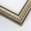 This highly detailed, solid wood frame features three distinct designs.  The dominant design tops a deep scoop of smooth, brushed silver foil and meets a small detail on the inner lip.  A drop ledge on the outer edge is decorated in a simple dash.  Matte areas within the designs create an antiqued look.

2 " width: ideal for medium- to large-size images. The detailed nature of this frame makes it suitable for bright or busy paintings or photographs.  It may overpower simpler images.