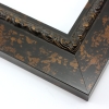 This flat profile, solid wood frame features a scroll and dot relief design along the inner edge.  The entire frame is a matte black with copper touches.  

2.5 " width: ideal for medium to extra large images.  Highlight a traditional black and white photograph, oil painting or Giclée print.  The extension of the flat outer edge beyond the relief detail ensures the frame will not detract from your image.