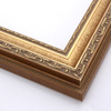 This highly detailed, solid wood frame features three distinct designs.  The dominant design tops a deep scoop of smooth, brushed gold foil and meets a small detail on the inner lip.  A drop ledge on the outer edge is decorated in a simple dash.  Matte areas within the designs create an antiqued look.

2 " width: ideal for medium- to large-size images. The detailed nature of this frame makes it suitable for bright or busy paintings or photographs.  It may overpower simpler images.